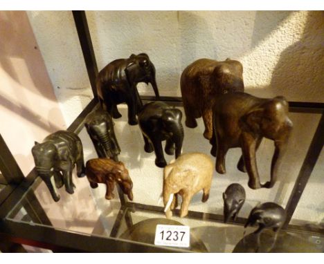 WOODEN ELEPHANTS. Ten wooden elephants, some with ivory tusks