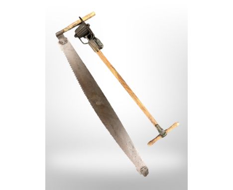 A 19th century two-man saw and an Atco lawn edging tool 