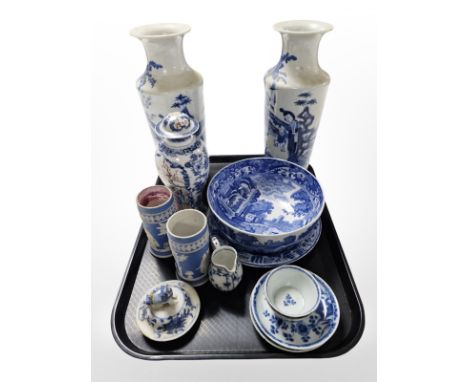 A pair of Chinese blue and white porcelain tapering vases depicting figures in a garden, with four-character mark to base, he