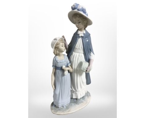 A Nao figure of a mother and daughter, height 37cm, and an Italian figural table lamp.