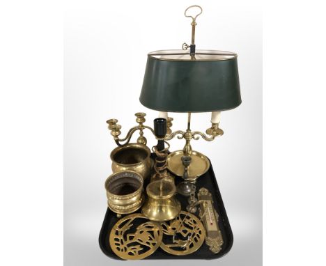 A brass twin-sconce table lamp, a further lamp base, brass candelabrum, trivets, pricket candle stand, thermometer, etc.