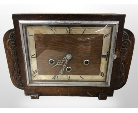 An Art Deco carved oak mantle clock, height 22 cm