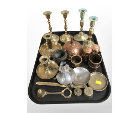 A group of brass candlesticks and chamber sticks, copper wine funnel, pewter candlestick, letter knife, and other metal wares