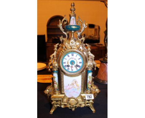ORMOLU REPRODUCTION CLOCK. Ormolu reproduction clock with key and pendulum