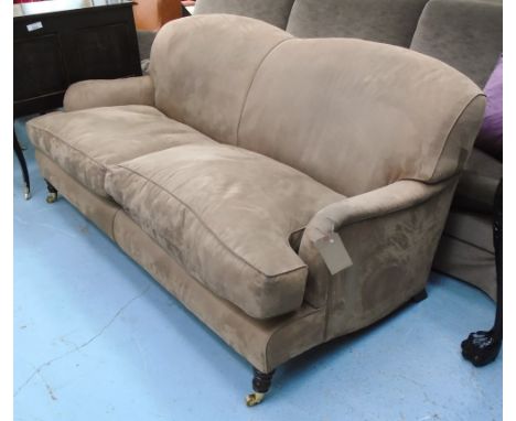 SOFA, two seater, Howard style in brown suede on turned castor supports, 187cm L.