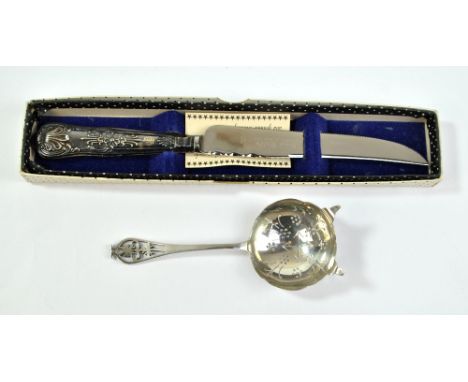 VINER'S LTD; an Elizabeth II hallmarked silver tea strainer with pierced foliate motif terminal, Sheffield 1956, length 15cm,