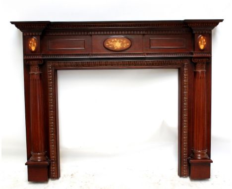 A reproduction fire surround with moulded and inlaid foliate detail with columns flanking aperture, size of aperture approx 8