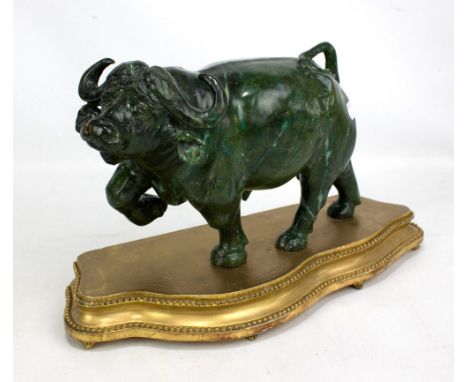 FABAIANO M SHATA (20th century); a carved green marble sculpture of a bull pawing the ground, etched signature to underside, 