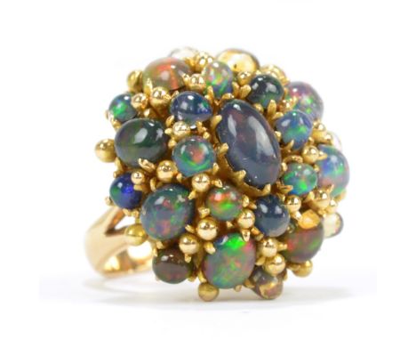 An 18ct yellow gold and opal set domed ring, ring size O, approx 17.8g.