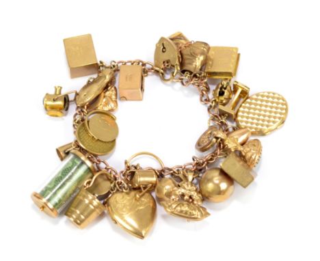 A 9ct yellow gold charm bracelet set with numerous charms including bank notes, book, lantern, skittle, pendant, ring, etc, t