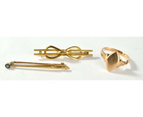 Two yellow metal brooches, one set with blue stone and the other a bow motif, and a 9ct yellow gold signet ring (cut), gold a