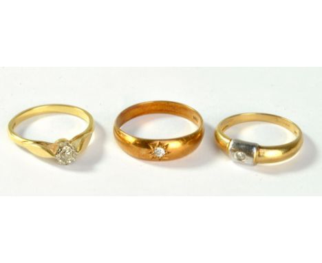 An 18ct yellow gold and diamond solitaire ring with illusion setting and raised platform, size P, a yellow metal and diamond 