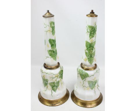 A pair of Victorian white opaque glass table lamp bases of faceted mallet forms painted with ivy leaves, on gilt tin bases, h