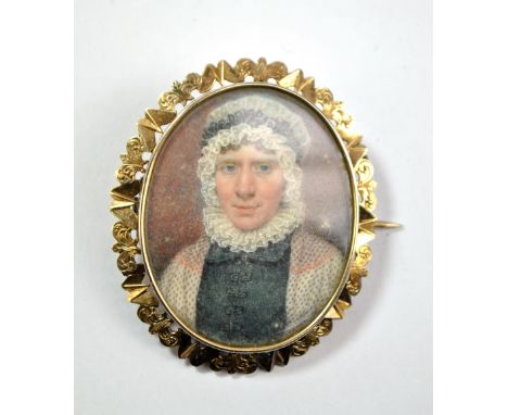 An early to mid-19th century gold plated oval mourning brooch with miniature portrait of female to obverse, both sides glazed