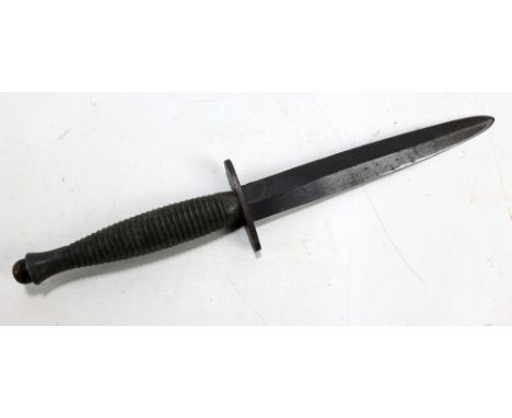 A Fairbairn-Sykes type fighting knife with tapered blackened blade, blade length 15.5cm, to oval crossguard and ribbed grip, 