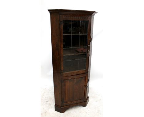NIGEL GRIFFITHS; a handmade 20th century oak 'No. 4' freestanding corner cupboard with glazed upper section, raised on bracke