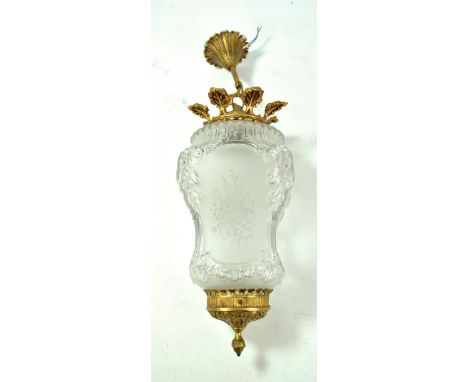 An early 20th century clear glass lantern shaped ceiling lamp with etched floral motifs to sides and with gilt metal mounts, 