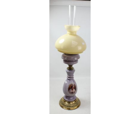 A lilac glazed transfer decorated and brass mounted oil lamp converted to electricity, height 59cm.