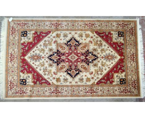 A beige ground Heriz carpet, 230 x 160cm.