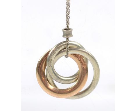 TIFFANY &amp; CO; a sterling silver and rubbed metal three tone interlocking circles pendant featuring Classic 1837 stamp sus