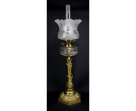 An early 20th century Art Nouveau floral motif brass oil lamp on hexagonal base with clear glass reservoir and floral etched 