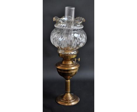 A brass oil lamp with duplex burner, clear glass shade with crimped rim and chimney, height 54cm.Additional InformationShade 
