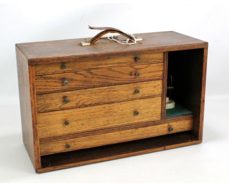 An oak five drawer box containing various engineering and drafting tools including pairs of compasses, small spanners, etc.&n