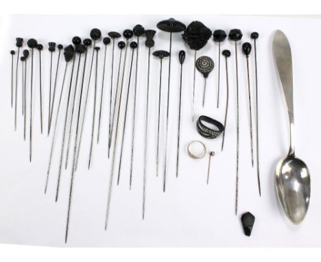 Approximately thirty black glass topped hat pins of various length, a gilt metal stick pin and a 9ct yellow gold signet ring 