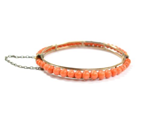 A Victorian graduated bead and gold plated framed snap bangle with safety chain, aperture 6 x 5cm.Additional InformationWear 