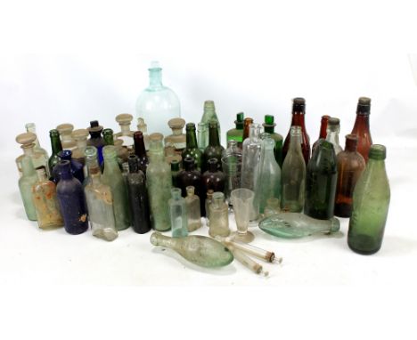 A collection of vintage chemist bottles including coloured examples, further local interest bottles including Parkinson Miner