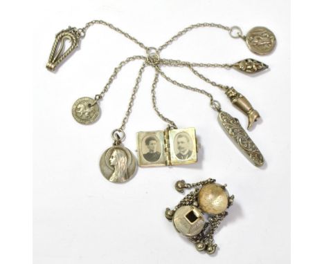 A white metal multi strand chain suspending various items to include a pen knife/glass hook, a miniature photo album and a lo