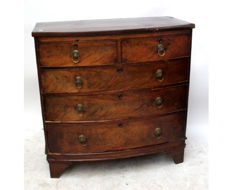 An early 19th century mahogany and stained chestnut bowfronted chest of two short over three long drawers raised on bracket f