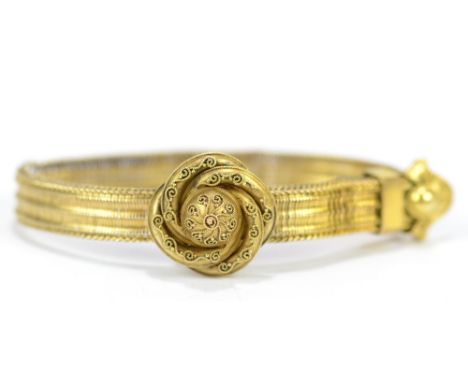 An unusual Victorian yellow metal bracelet with filigree decoration to the bracket clasp and with sliding adjustable frame, u