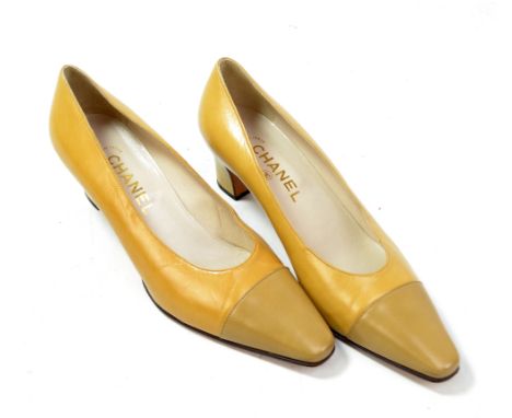 CHANEL; a pair of lady's two tone tan leather high heels, size EU 39, length of heel approx 2 inches, each in protective bag.