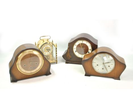 Three early 20th century mantel clocks comprising Smiths and two oak examples, also a Koma brass domed anniversary clock (4).