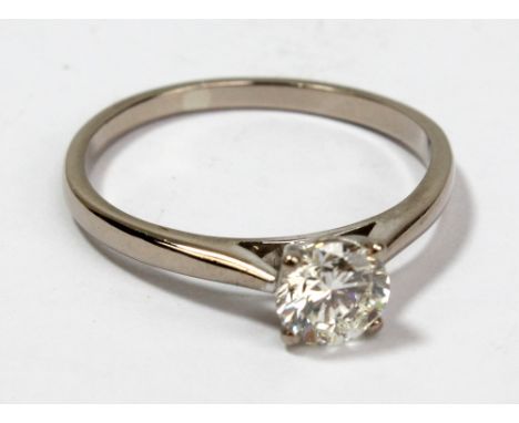 A white metal and diamond single stone solitaire ring, the round cut stone weighing approximately 0.8ct, size P, approx 2.5g.