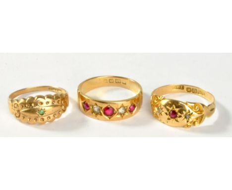 An 18ct yellow gold ring with central red stone flanked by diamond chips, size Q, a similar 18ct ring set with red and white 