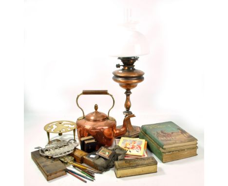 A mixed lot of various items to include a copper kettle, an oil lamp, a group of books to include 'Tricks and Magic', an elec