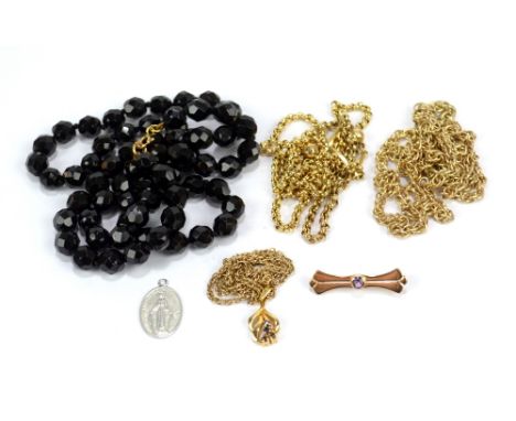 A 9ct yellow gold pendant suspended on a 9ct fine link chain (approx 4.7g), a black bead necklace, two further yellow metal c