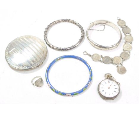 A silver hinged snap bangle, a Swiss silver open face fob watch, two bangles, a compact, a ring and a coin bracelet.