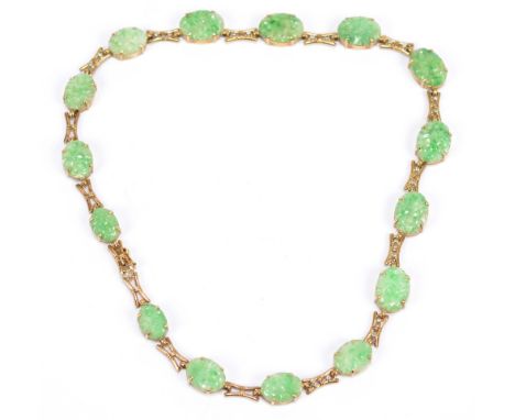 A yellow metal jade and diamond necklace, the pierced frame set with fifteen slightly graduated carved oval jade plaques inte
