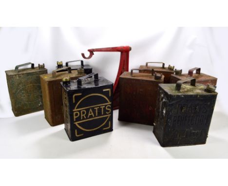 Eight circa 1930s fuel cans to include Pratts, Shell and Esso, also an Avery wall mounted cast iron bracket (9).