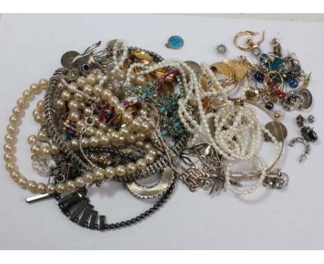 A group of costume jewellery including necklaces, simulated pearls, brooches, signet ring, etc.