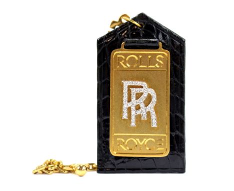 ROLLS ROYCE; an unusual 18ct yellow gold key fob with simulated crocodile skin leather back, gold flat panel set with the ini