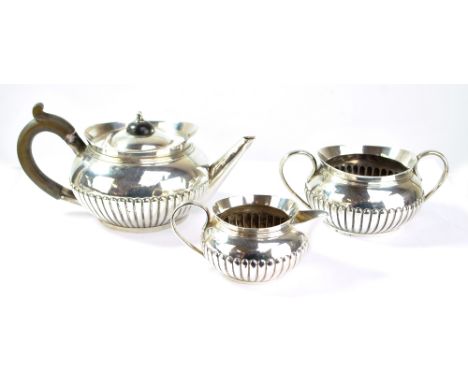 HUKIN &amp; HEATH; a Victorian hallmarked silver three piece bachelor's tea set comprising a squat globular part gadrooned te