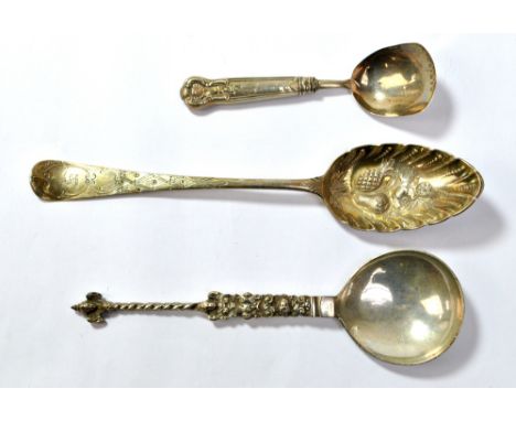 Three various silver spoons comprising a berry spoon with crested terminal, London 1797, maker's mark obscured, length 22cm, 