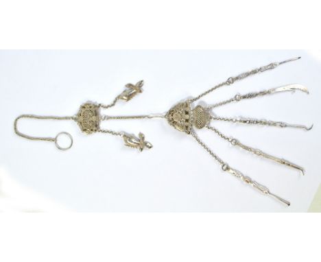 An early 20th century Chinese Export white metal filigree, foliate scroll and floral motifs decorated chatelaine, the central