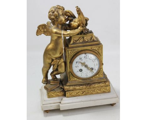 A late 19th century French gilt metal and white marble figurative mantel clock, the white enamel dial set with Arabic numeral