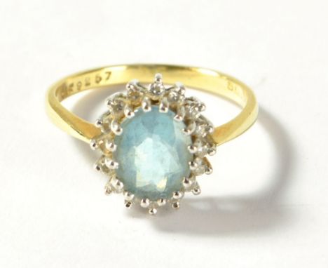 An 18ct yellow gold ring set with oval cut light blue coloured stone surrounded by small white stones, size N, approx 4.0g.&n