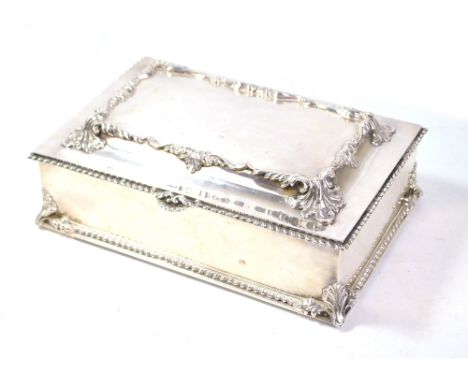 CARRINGTON &amp; CO; an impressive large Edward VII hallmarked silver cigar box with raised acanthus leaf and scroll decorate